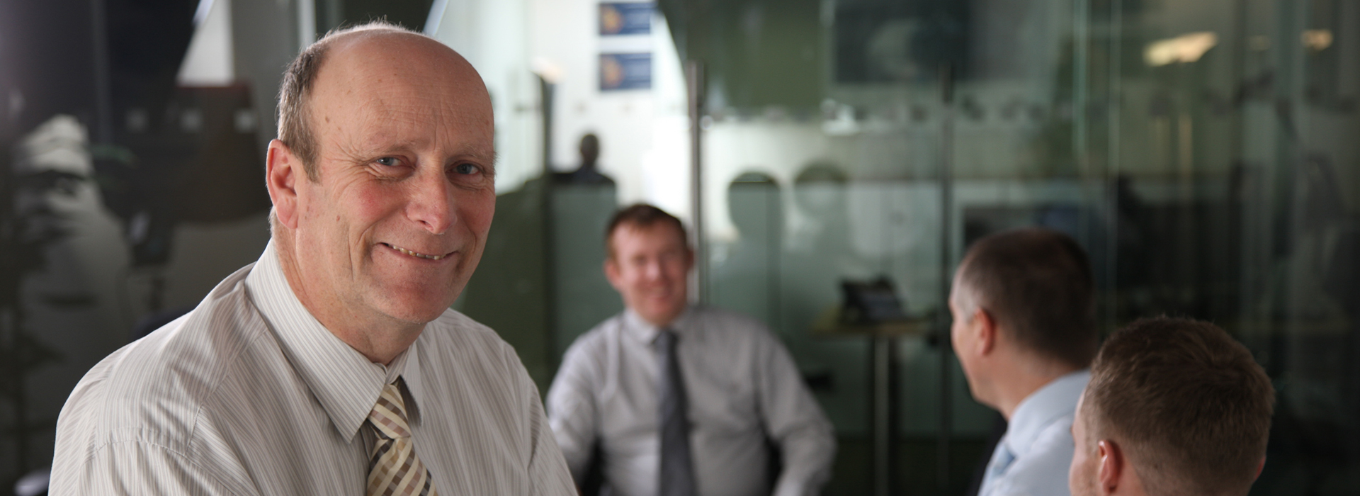 Man at work with colleagues in background